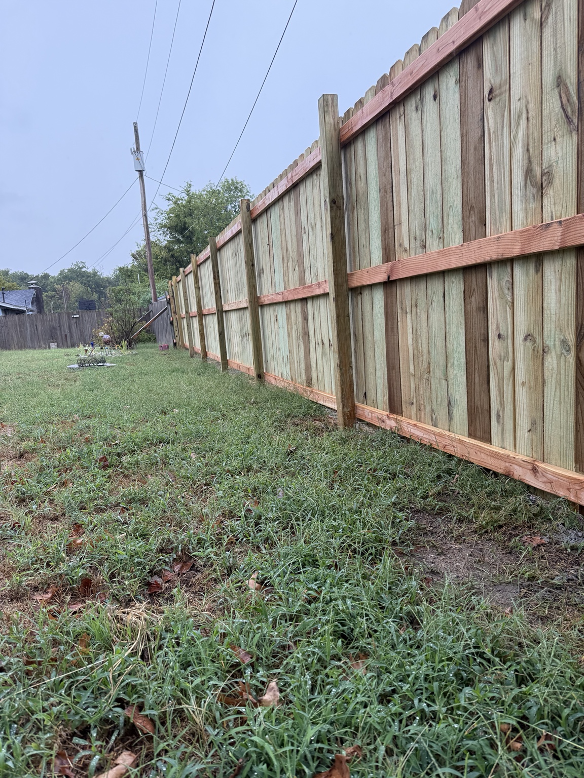 Fence line showing posts and three horizontal rails