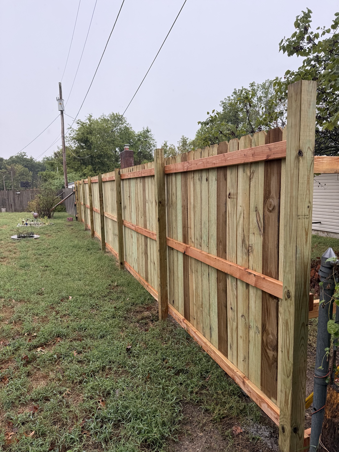 Finished fence with posts and rails visible