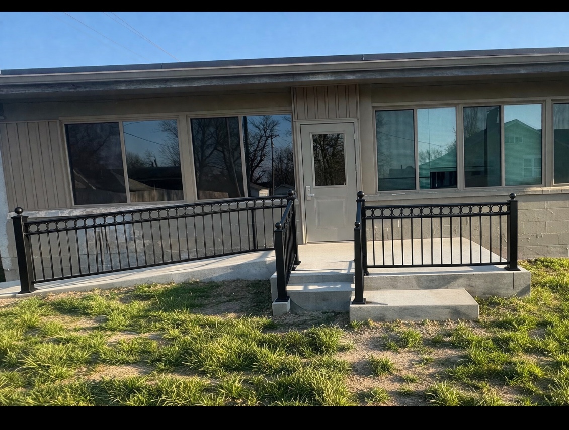 Black steel railing system across a commercial entry