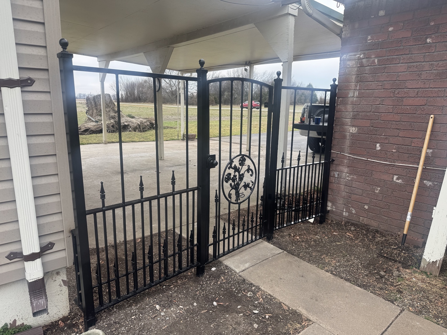 Custom ornamental steel entry gate and side panels