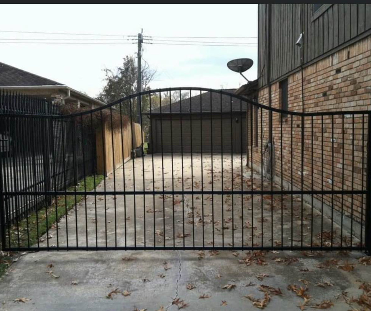 Large black steel arched driveway gate