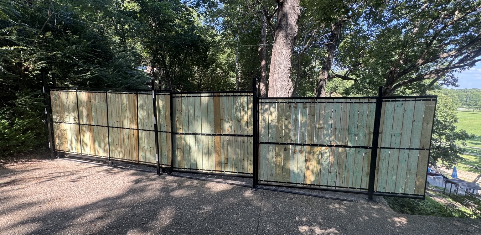 Large steel framed driveway gate with wood infill